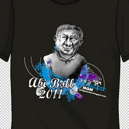 Schwarzes T-Shirt mit buntem Porträt eines Mannes und dem Text "Abi Ball 2011", umgeben von farbigen Mustern.