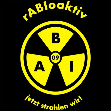 Gelbes Radioaktivitätszeichen auf schwarzem Hintergrund, mit den Buchstaben B, A, I und der Zahl 09, sowie dem Text "jetzt strahlen wir!"